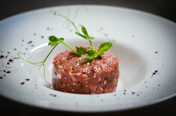 delicious beef tartar close up with fresh ingredients