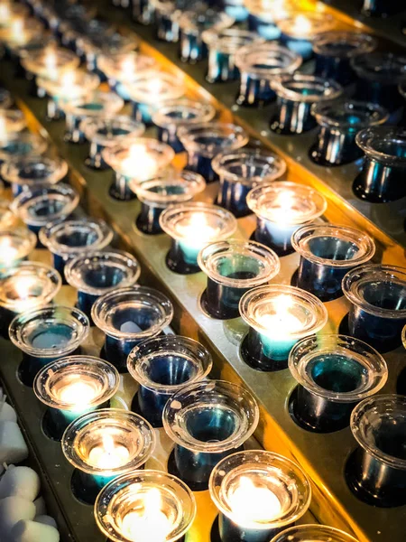 lighted candles within the parisian cathedral notre dame