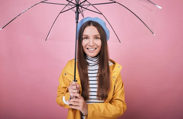 Cheerful lady in blue beret, striped blouse and rain jacket with umbrella — Stock Photo, Image