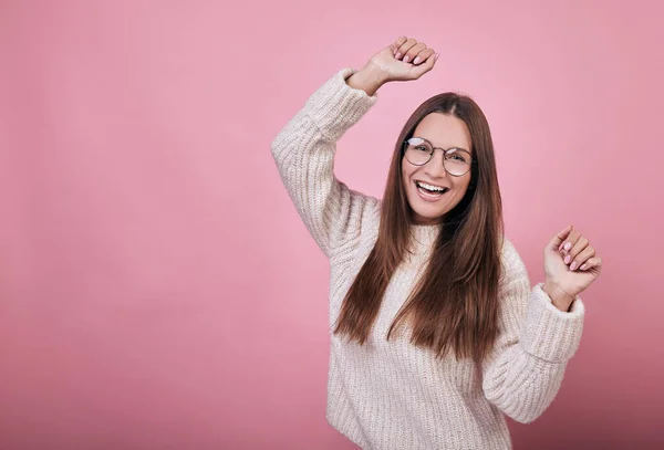 Cool nice girl in transparent glasses in a knitted sweater dancing and having fun — Stock Photo, Image