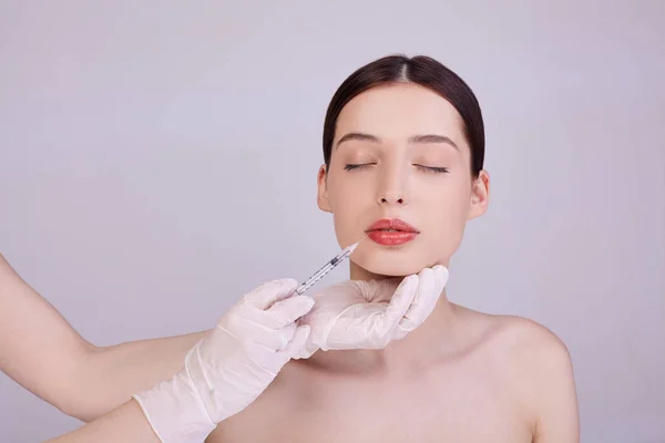 Beautician makes an injection on the lips of a girl. — Stock Photo, Image