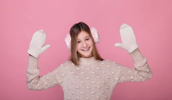 Smiling teenage girl in fur headphones and knitted mittens. — Stock Photo, Image