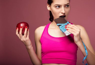 Ciddi bir kız çikolata ısırıyor..