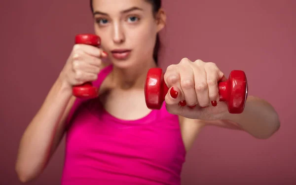 Wonderful girl using dumbbells in gym. — 스톡 사진