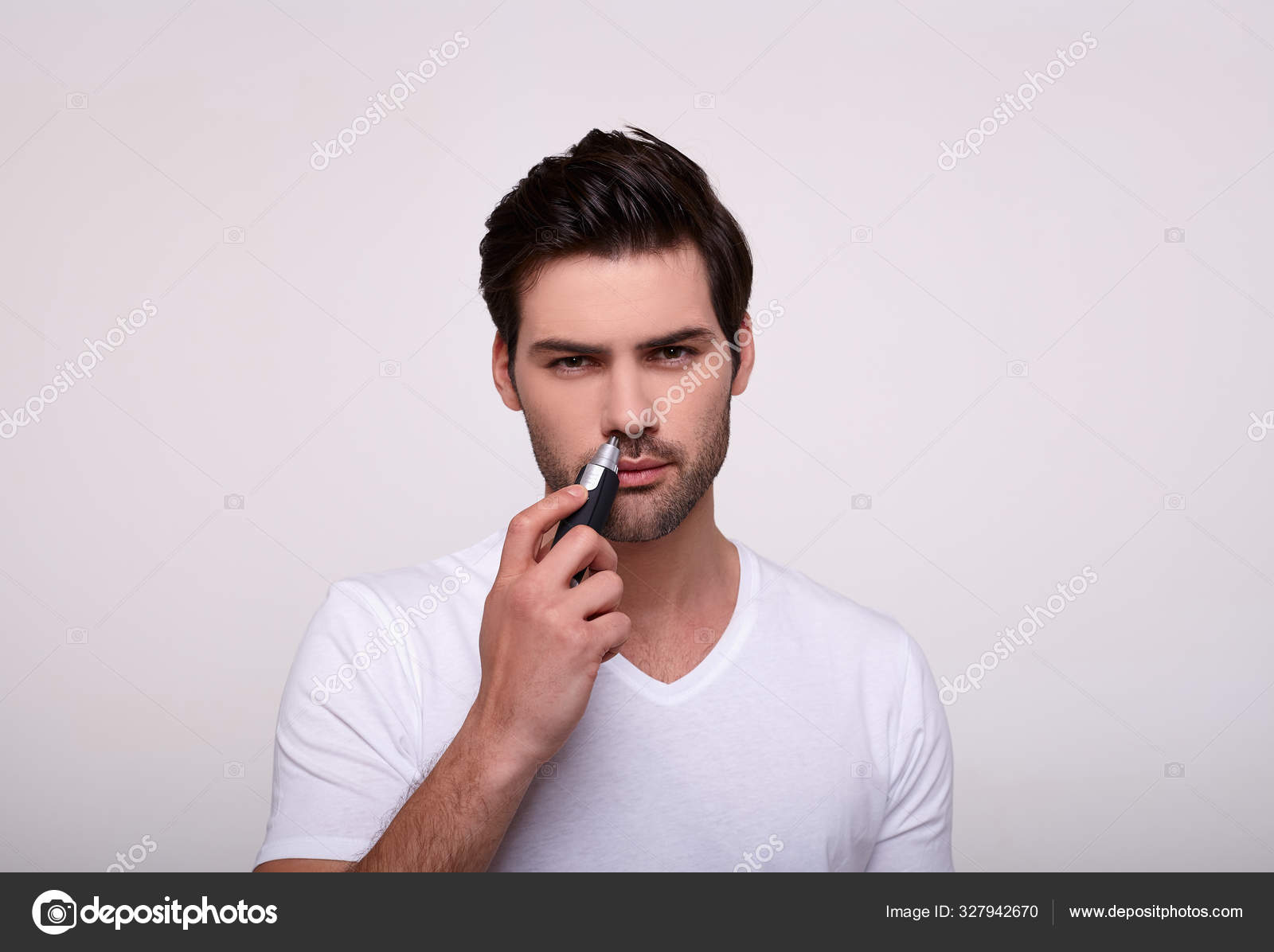 Cute White Guy With A Trimmer In His Hand Removes Hair In His Nose