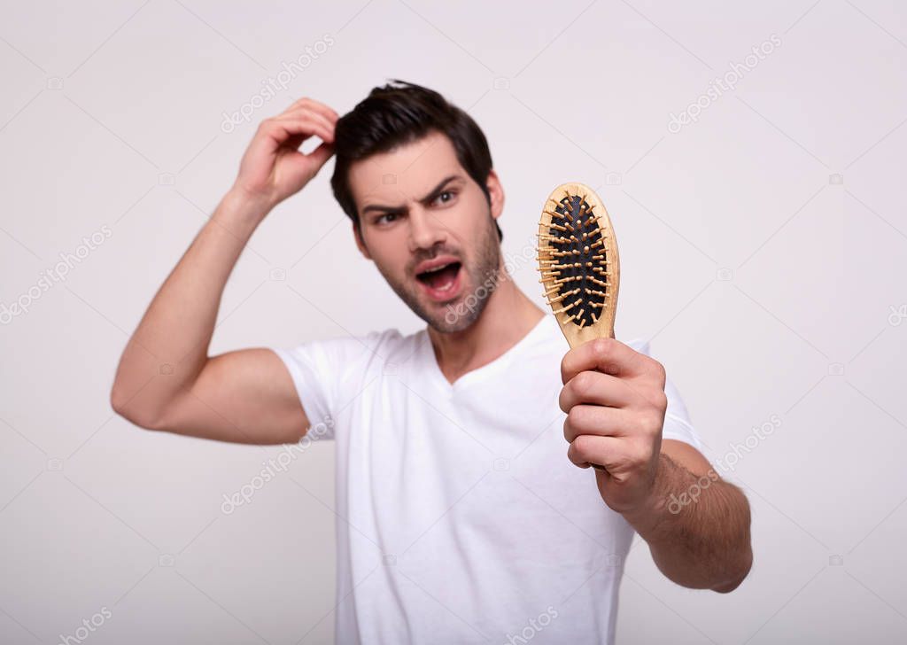 Young man serious hair loss problem for health care medical and shampoo product concept.