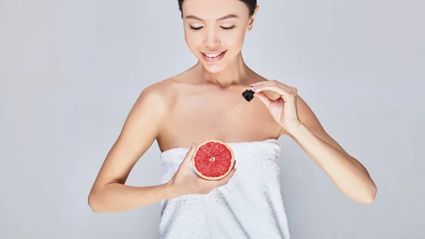 Cropped frame, Asian after showering with body oil with grapefruit extract, citrus. — 스톡 사진