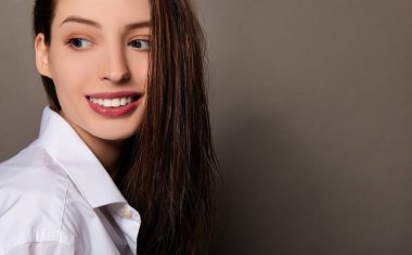 A close-up, image of a young beautiful woman with wet hair.