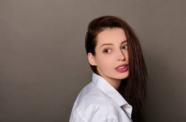 An image of a young beautiful woman with wet hair.