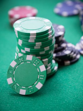 Yeşil masada poker fişleri yığını