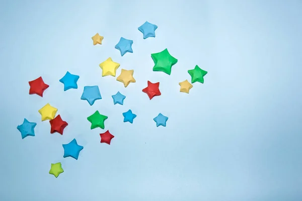 red, yellow, blue and green stars on a blue background