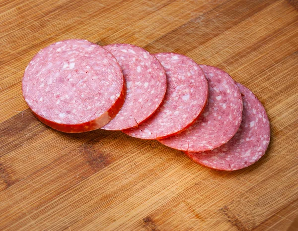 Slicing sausage on a cutting Board — Stock Photo, Image