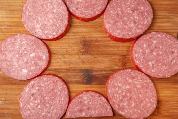 Slicing sausage on a cutting Board — Stok fotoğraf