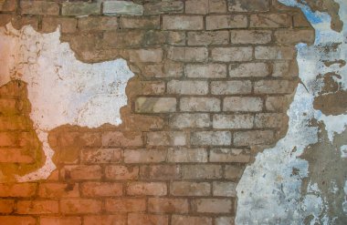 texture of old white brick wall with remnants of plaster