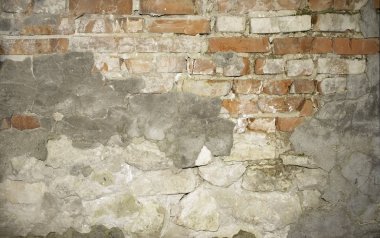 wall of old brick with remnants of plaster