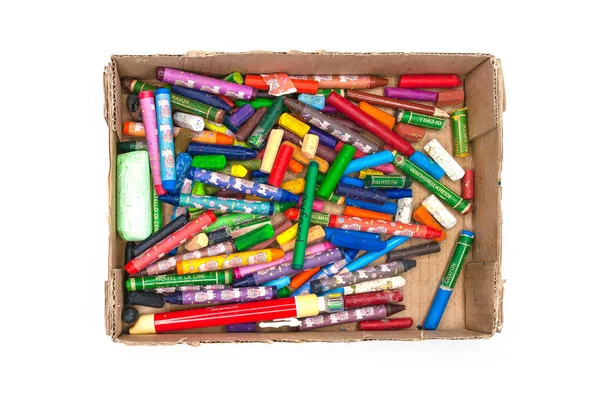 colored pencils and crayons in an open box