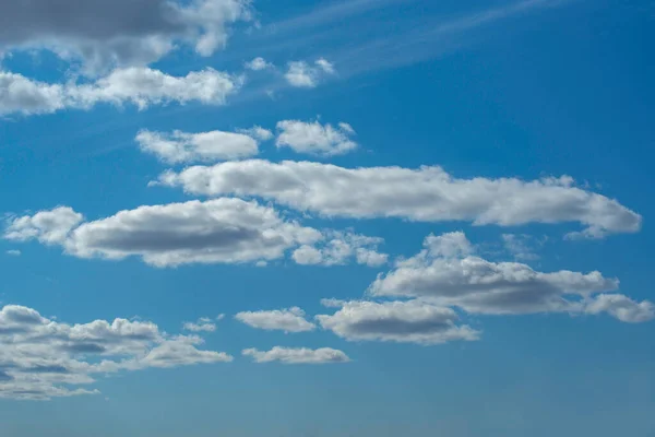 Mavi gökyüzünde beyaz kümülüs bulutları.