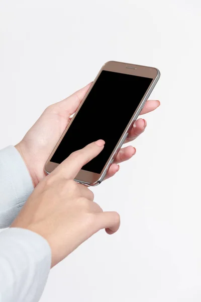 Mano femenina aislada sosteniendo un teléfono con fondo blanco . — Foto de Stock