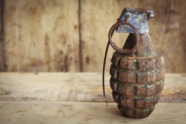 Grenade on old wood for background and texture  clipart