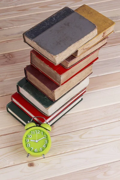Concept groene watchon en vintage oude boeken over hout achtergrond. — Stockfoto