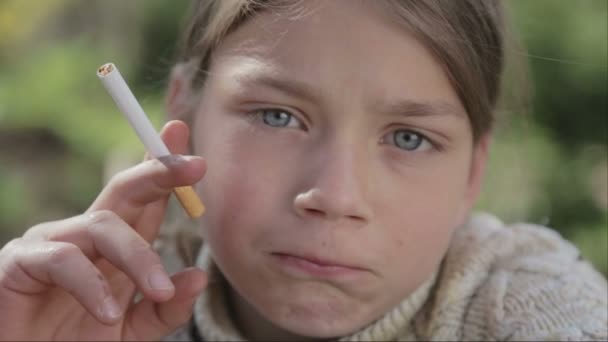 Portrait of a boy with a cigarette in his hand. Anti tobacco video. For a healthy lifestyle. — Stock Video