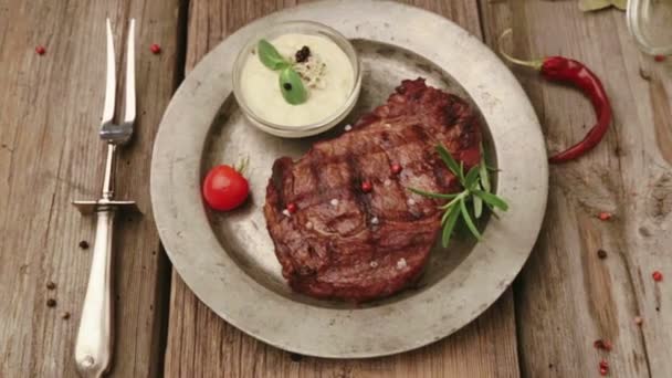 Složení s steak a koření na talíři. Hovězí steak je krásně zdobené v restauraci. Správně smažený steak omáčky. — Stock video