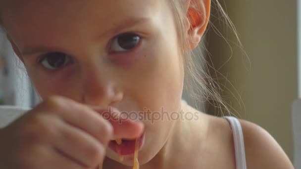 Retrato de uma menina comendo uma sopa. Uma criança branca está comendo sopa de legumes. Vídeos 4K — Vídeo de Stock