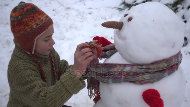 Boy Building Snowman Garden Child Winter Park Sculpts Snowman — Stock Video