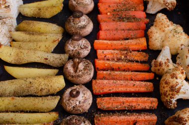 Pişirilmiş sebze tepsisi. Patates, tarla mantarı, havuç, karnabahar..