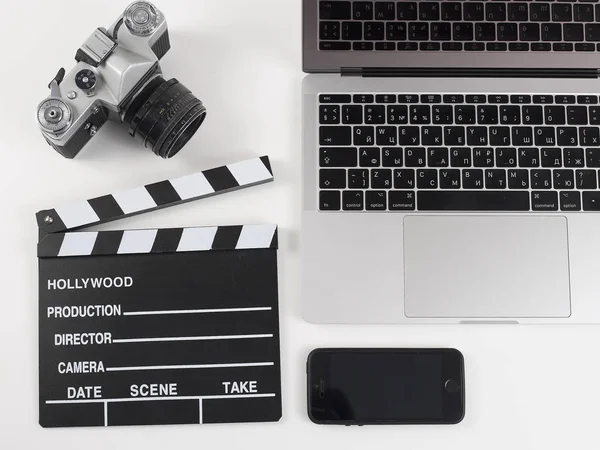 Camera with laptop and cell phone and clapper movie isolated on — Stock Photo, Image