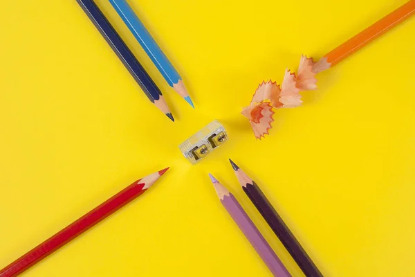 Some colored pencils of different colors and a pencil sharpener — Stock Photo, Image