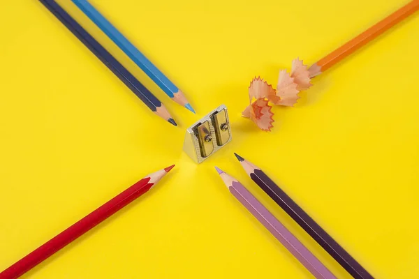 Some colored pencils of different colors and a pencil sharpener — Stock Photo, Image