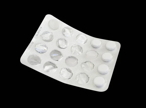 Gebruikte blisterverpakking van tabletten geneeskunde geïsoleerd op zwarte backgr — Stockfoto