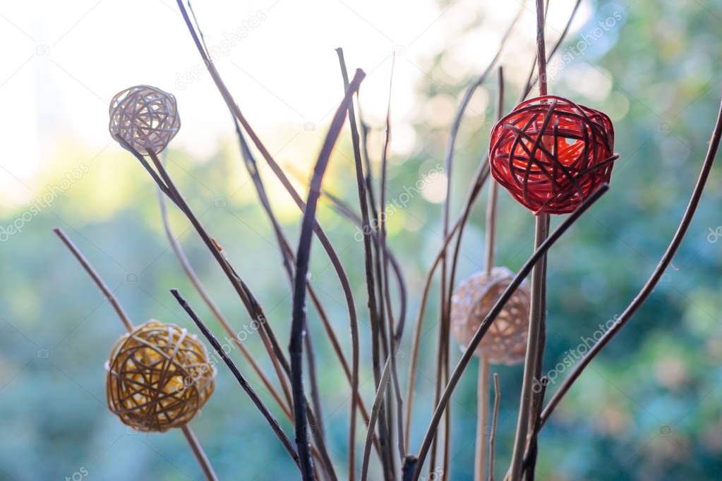 Modern decor braided balls on dry branches blurred bokeh backgro