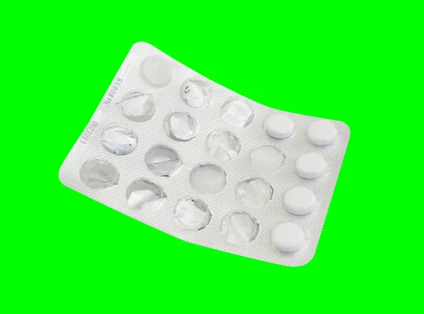 Plaquette thermoformée utilisée à partir de comprimés médicament isolé sur fond vert — Photo