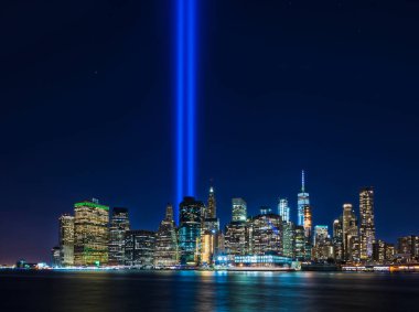 Clear view from Brooklyn of 911 memorial tribute light in Manhattan, New York City clipart