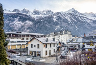 Typical house in Chamonix with massive alps snow mountain range in the background