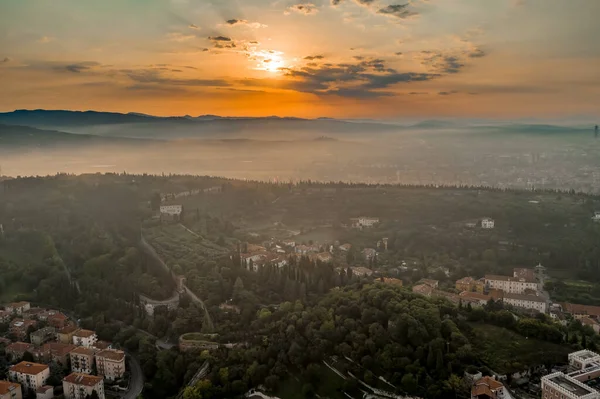 Aerial drone shot view of sunrise on foggy Veronetta colline with Castel San Pietro and funicolare — Zdjęcie stockowe