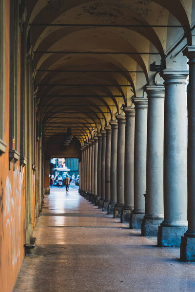 Empty ortico passage with roman style columns in Bologna, Italy