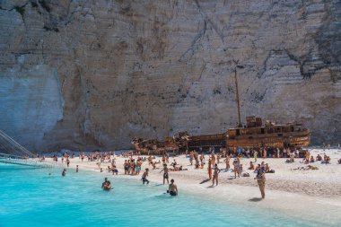 Zakynthos, Greece - August 20, 2019: Tourists on Shipwreck bay Nvagio beach in summer noon clipart