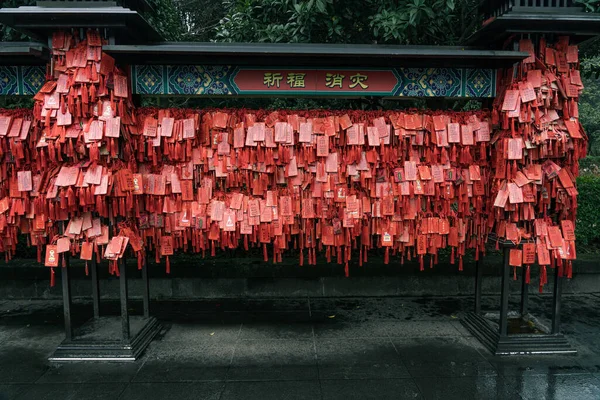 Red praying wish cards hang on traditional stand written in Chinese Pray Fortune, in Huayan Si temple — Stock Photo, Image