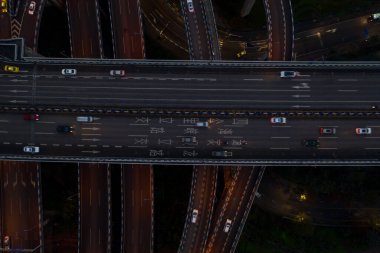 Aerial overhead shot of flyover highway traffic before dawn in Chongqing,Southwest China clipart