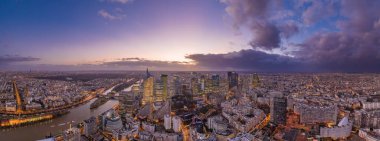 Panoramic aerial drone shot of la defense skyscraper complex with Eiffel tower and La seine during sunset clipart