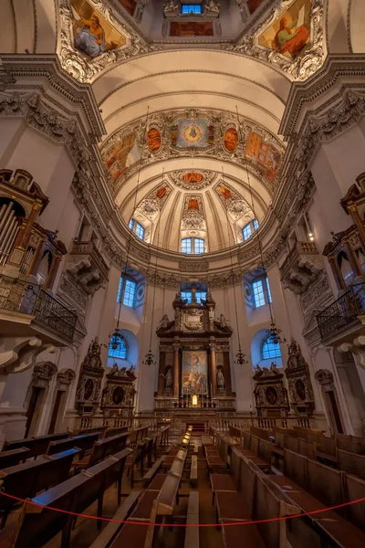 Ultrawide view of dome and ceiling with low light inside Salzburg Cathedral