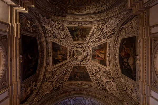 Ceiling mural with paintings inside Salzburg Cathedral with dim light