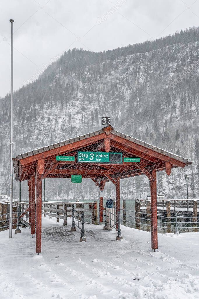 Dock no.3 by lake Konigssee during heavy snow in Germany in winter