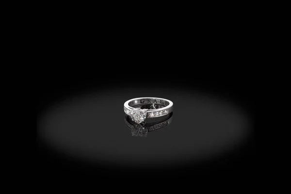 Silver Gold precious ring male with big heart  diamonds white and black on black background. Good material for article or post.