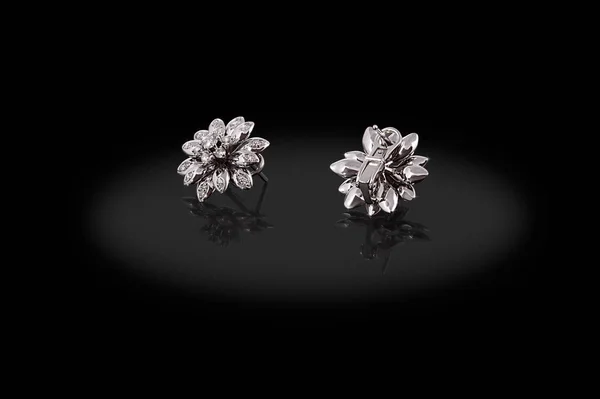 Brincos preciosos flor de prata com diamantes no fundo preto . — Fotografia de Stock