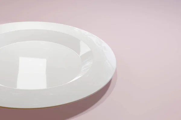 Classic white ceramic plate for a restaurant or cafe view from the side on a light pink Pastel background. An excellent blank for an advertising banner. Photorealistic 3D render. — 스톡 사진