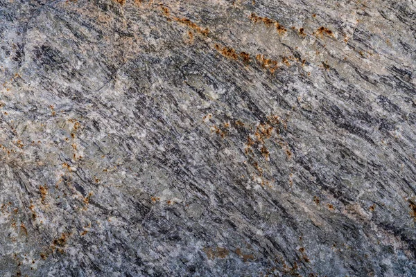 Texture of natural rock granite natural rock granite, magmatic structure with quartz and mica and traces of erosion and oxide.